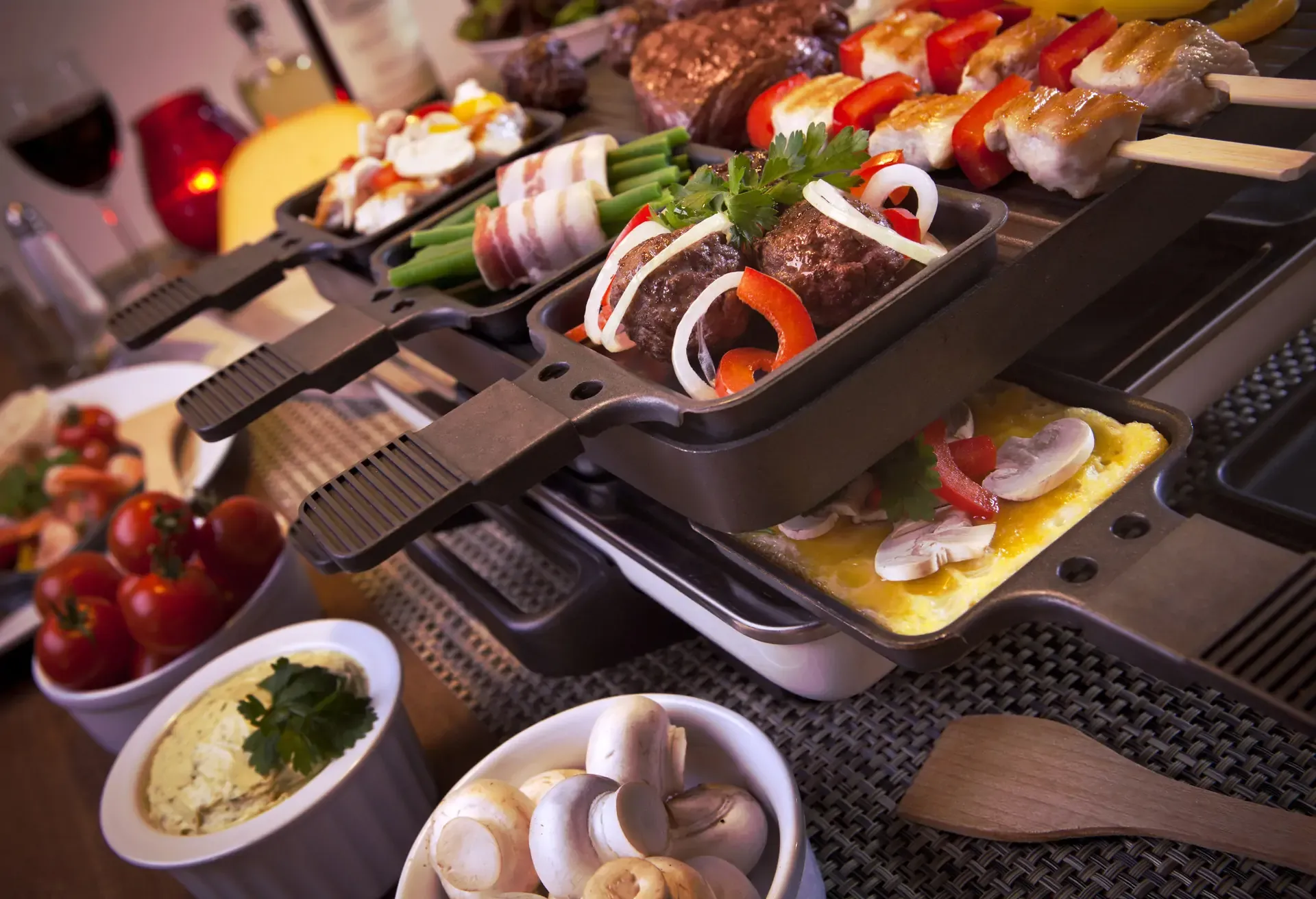Swiss raclette or the Dutch variant 'gourmetten'. A table filled with ingredients for a dish that is usually served on celebratory evenings like Christmas or New Years Eve in The Netherlands.; Shutterstock ID 306830186; Purpose: Virtual Christmas Guides; Brand (KAYAK, Momondo, Any): Kayak; Client/Licensee: KAYAK