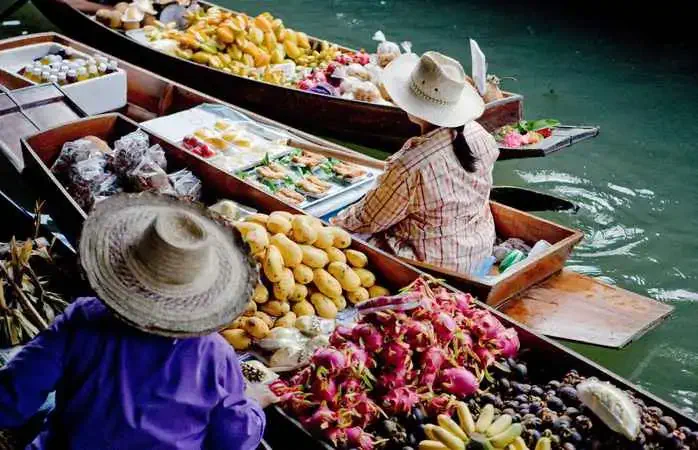 Floating market sellers in Thailand.