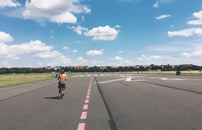 Woman cycling on Tempelhofer Feld, Berlin, Germany; Shutterstock ID 711136543