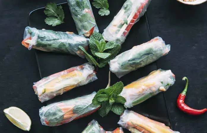 Vietnamese spring roll with vegetables, roasted peanuts and herbs, sauce, vegan